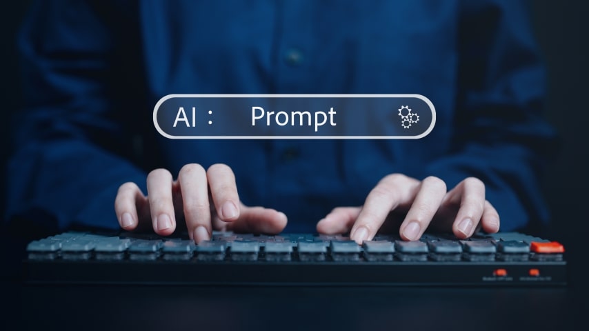 Person using a keyboard to input an AI text prompt.