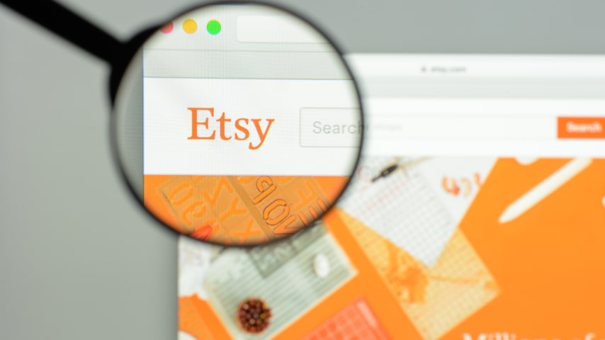 A magnifying glass enhancing Etsy's logo on its homepage.