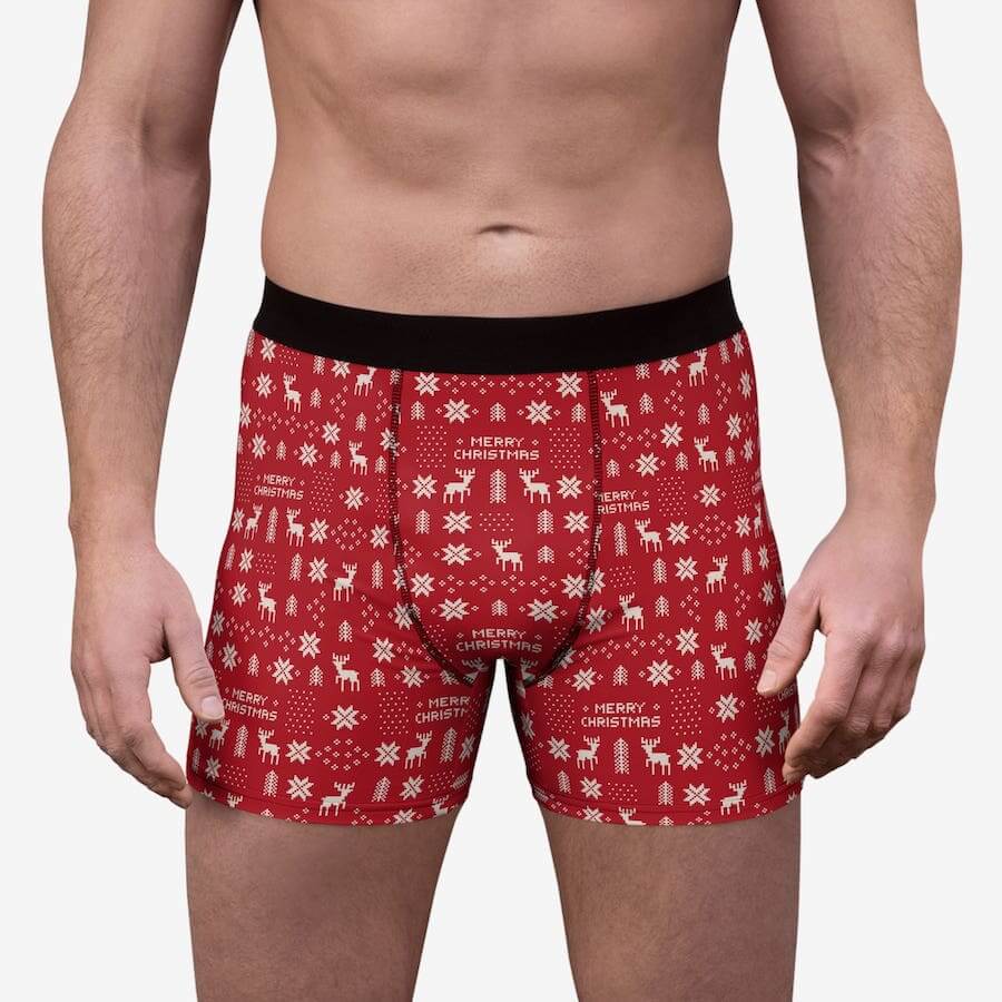 Boxer briefs with stylized snowflakes, reindeer, Christmas tree pattern, and the text: “Merry Christmas.”