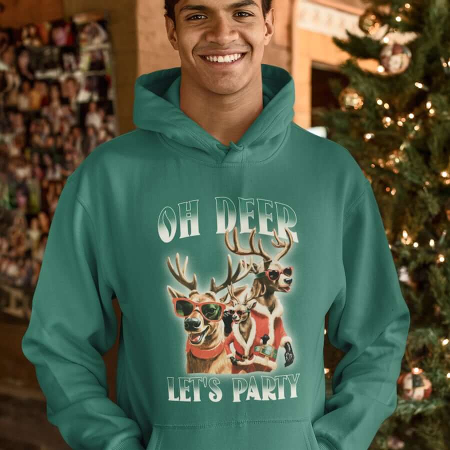 A smiling man wearing a green hoodie with stylized reindeer, suggesting that apparel is one of the best gifts for men.