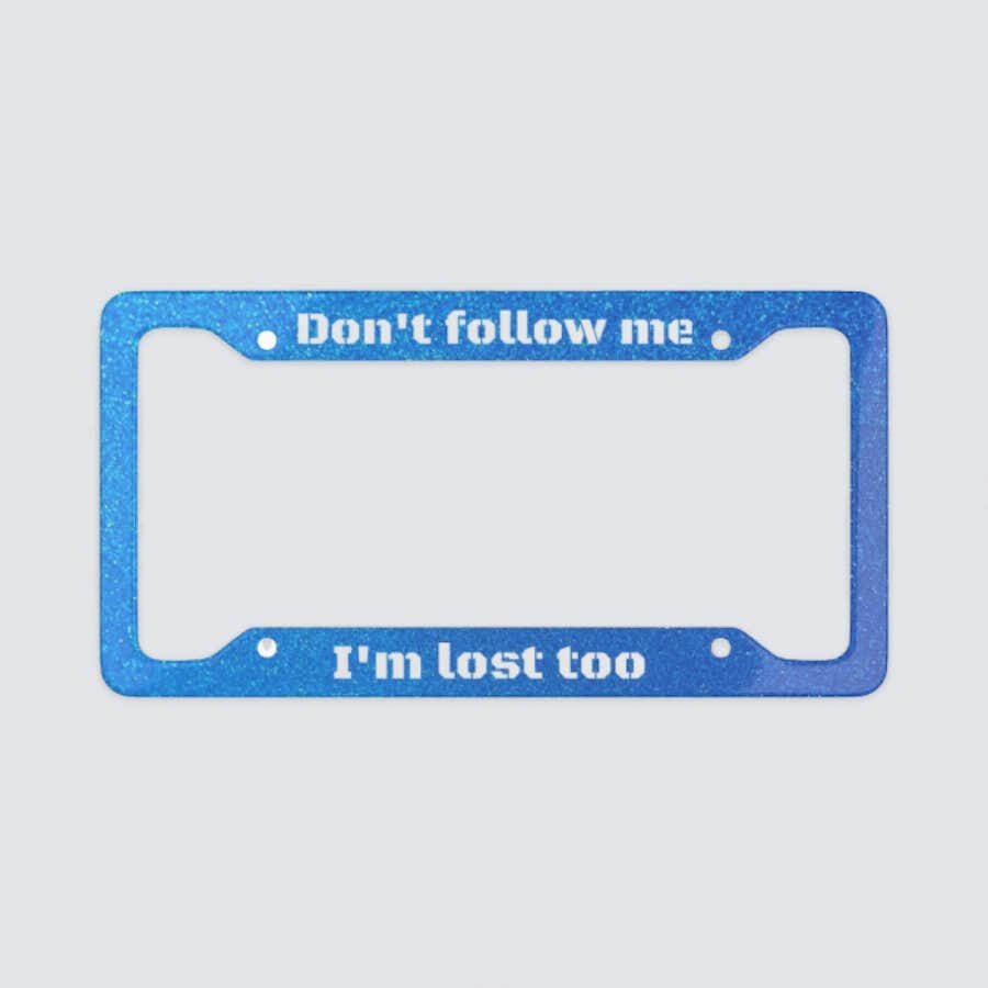 A blue license plate frame with the text: “Don’t Follow Me, I’m Lost Too.”