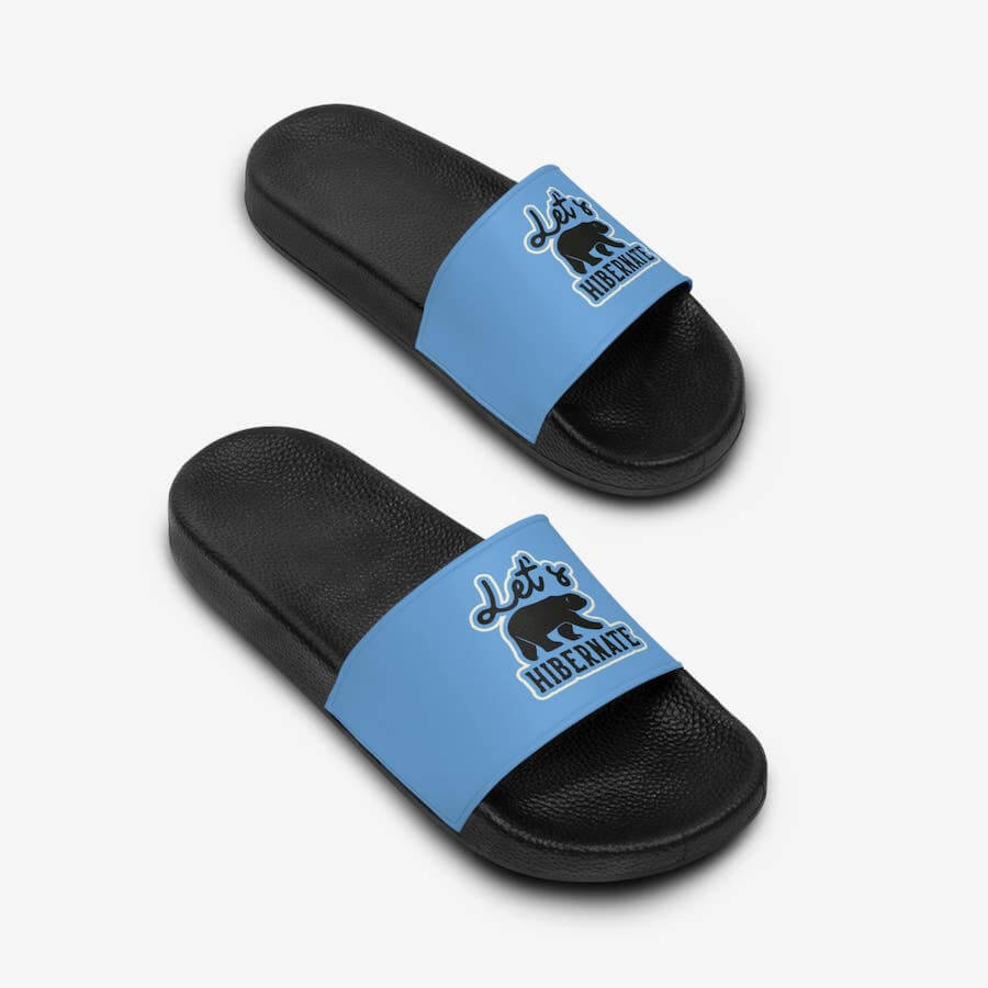 Sandals with a black sole and a blue strap with a stylized bear and the text: “Let’s Hibernate.”