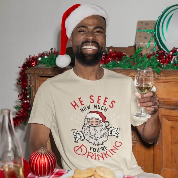 A man wearing a Santa Claus themed Christmas t-shirt.