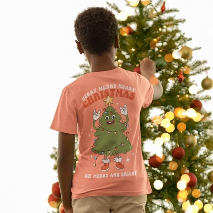 Coral Christmas t-shirt with an illustrated Christmas tree and text on the back.