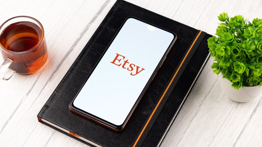 A smartphone displaying the Etsy logo on its screen.