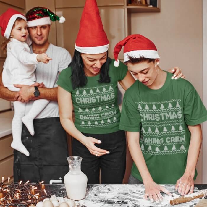A mom and son baking and wearing “Christmas Baking Crew” t-shirts.