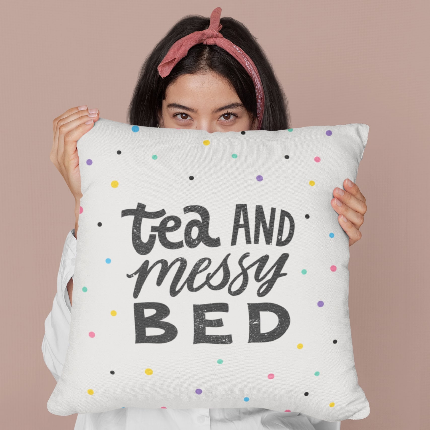 A custom cushion with “Tea and Messy Bed” text printed on.