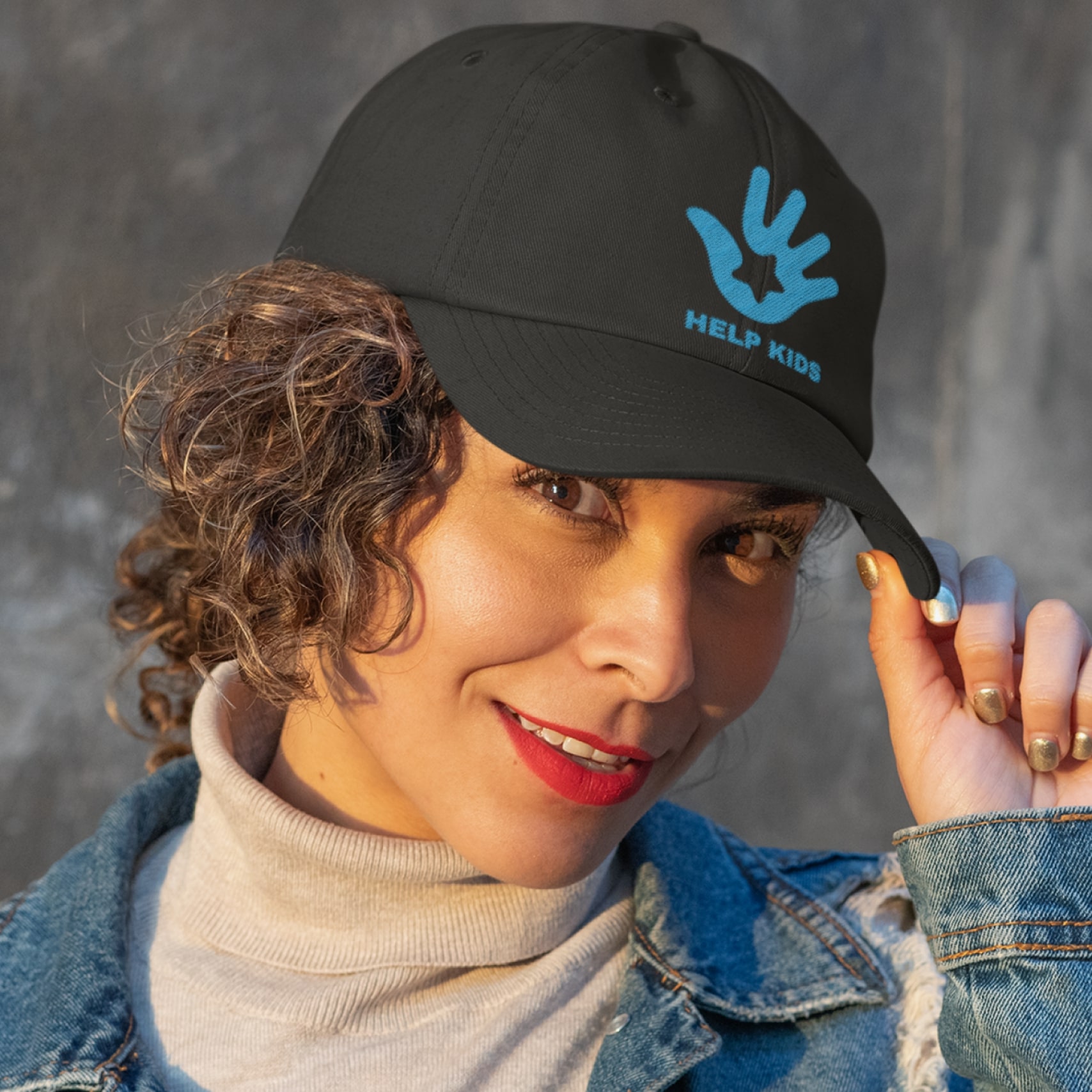 A woman wearing a dark custom cap with a logo.