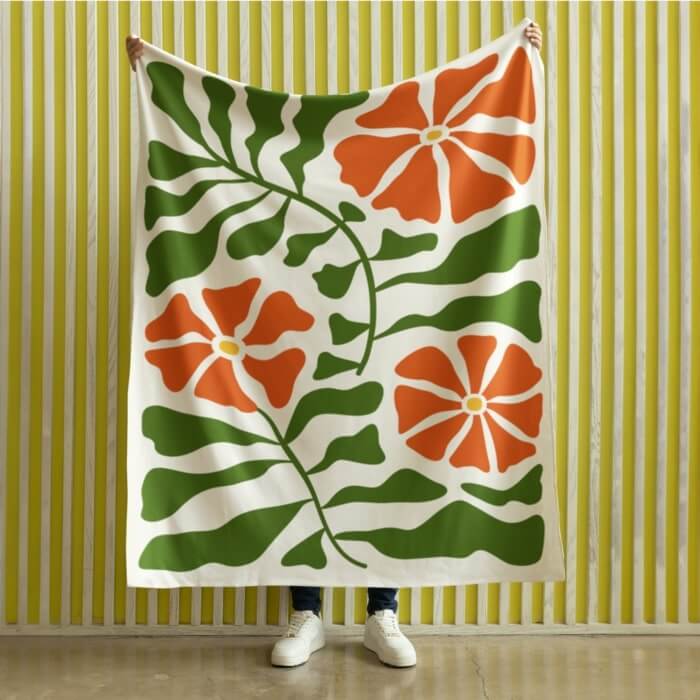 Custom velveteen blanket with a green and orange floral print.