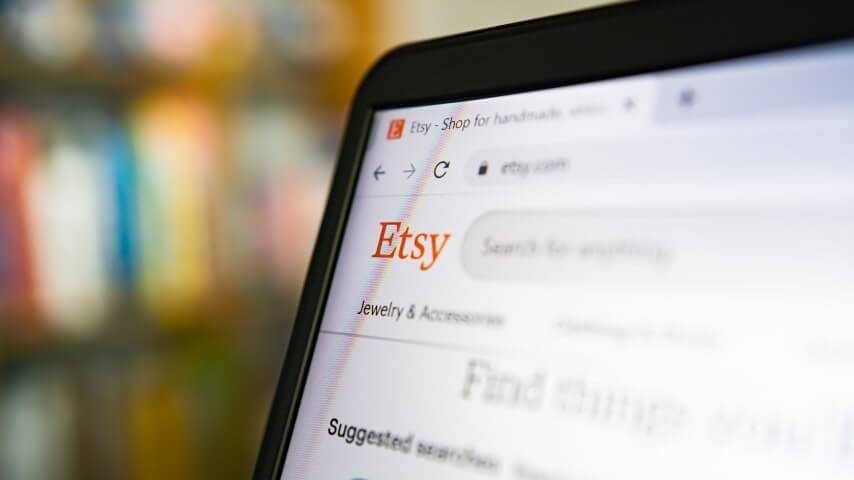 Etsy homepage on a laptop screen explaining how to sell photos on Etsy.