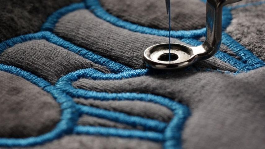 The process of embroidery, as one of the alternatives to screen printing.