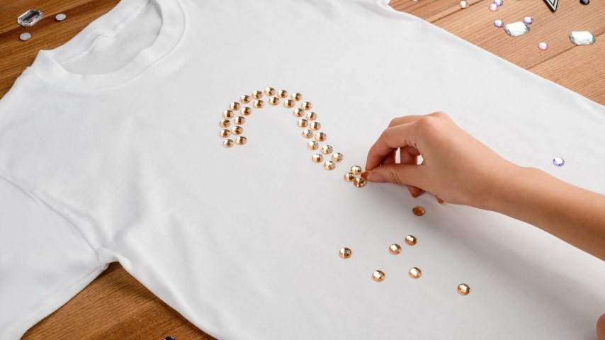 The process of rhinestone transfer, as an alternative to screen printing.