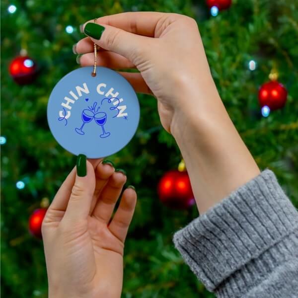A custom ceramic ornament with a wine glass illustration and “Chin Chin” text.