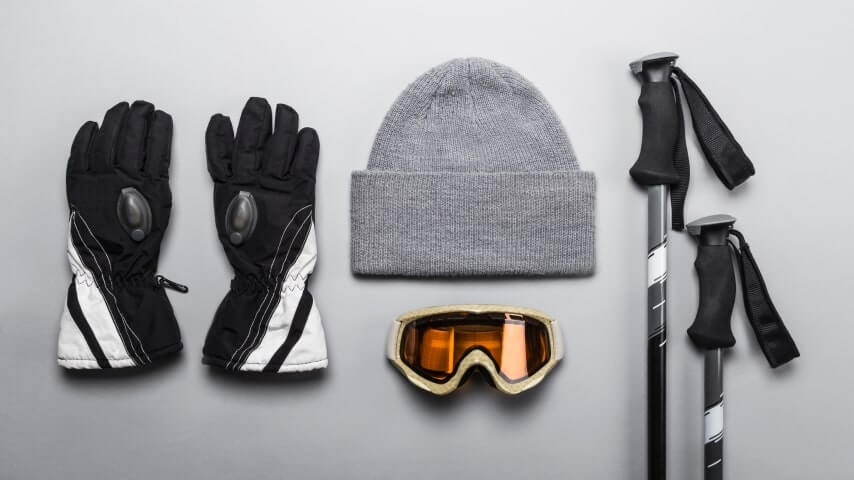 Equipment for skiing – gloves, beanie, and protective glasses.