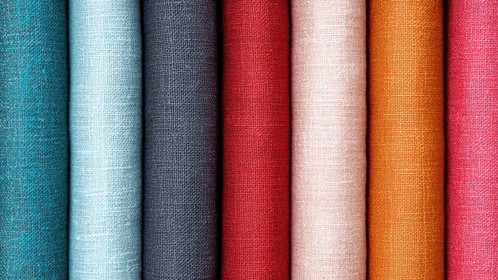 Cotton Rolls of different-colored cotton fabric stacked next to each other.