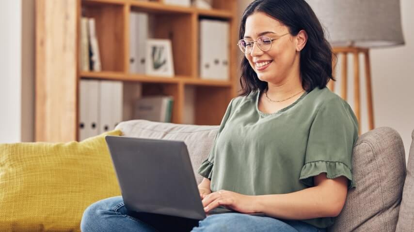 A woman researching how to sell greeting cards on Etsy with print on demand.