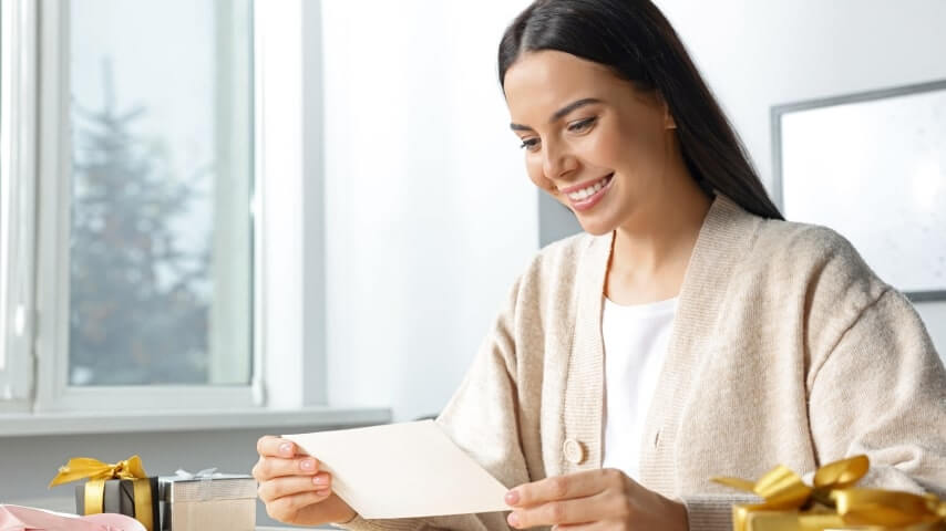 A woman making handmade greeting cards to sell on Etsy.