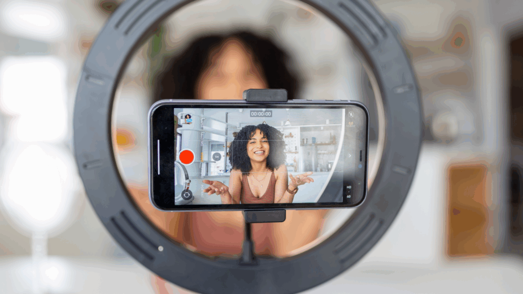 Get in on influencer marketing A young woman recording herself using a mobile phone on a tripod.