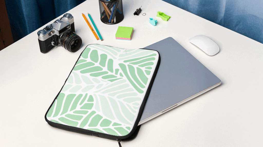 Laptop sleeve A laptop cover featuring a green leaf pattern.