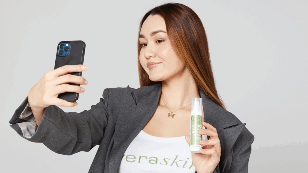 Organize a giveaway A young woman filming herself while presenting a product as a giveaway back-to-school marketing activity.