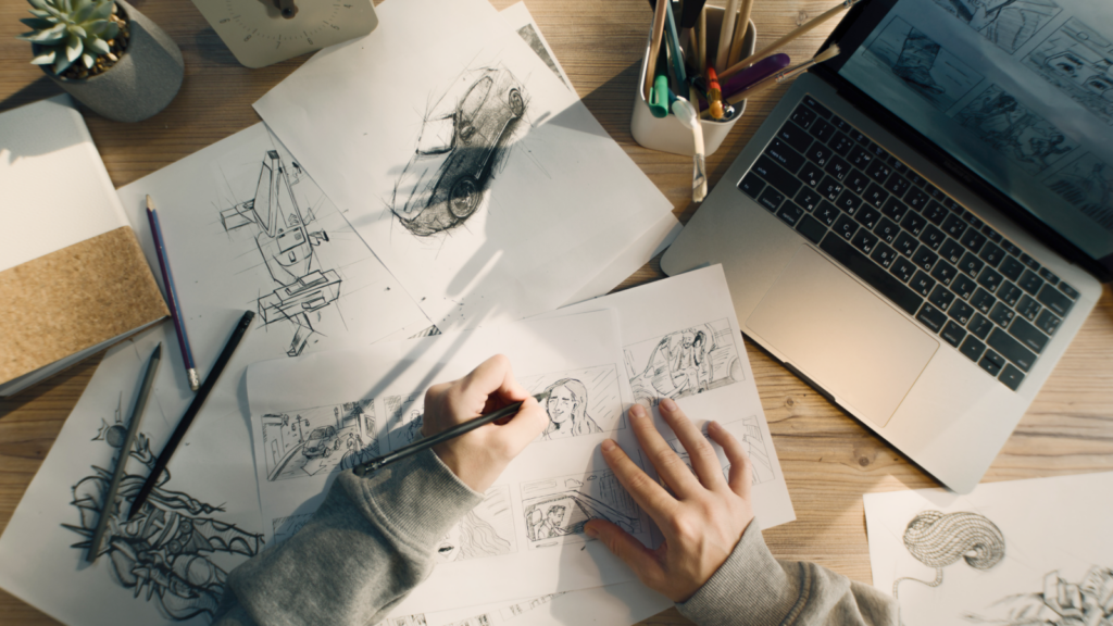 A person is drawing paintings on a paper.