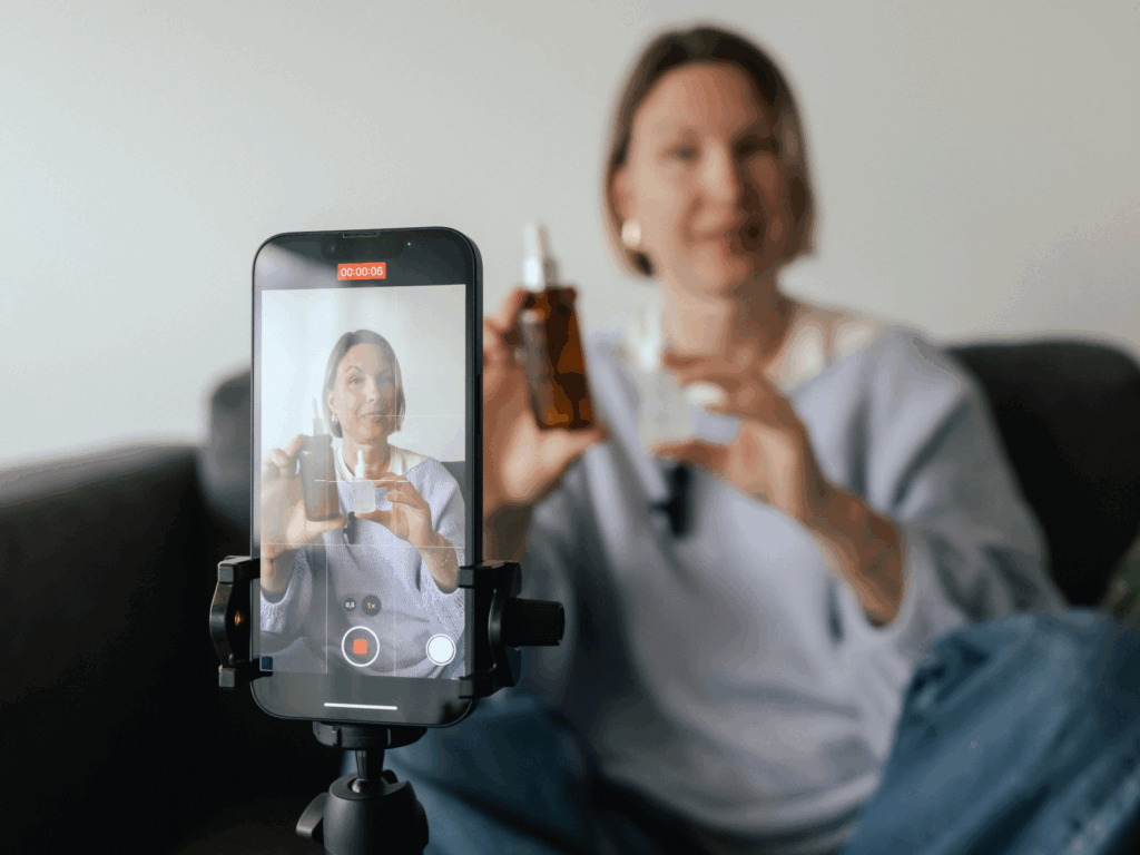 Affiliate marketing business A woman is recording a product presentation video using a mobile phone.