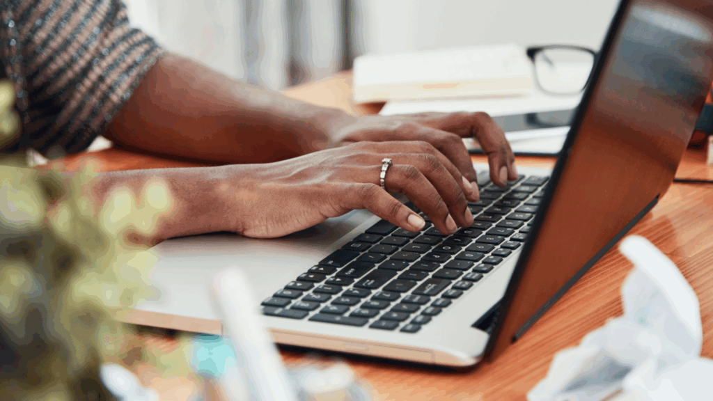 Translation services A person typing on a laptop keyboard.