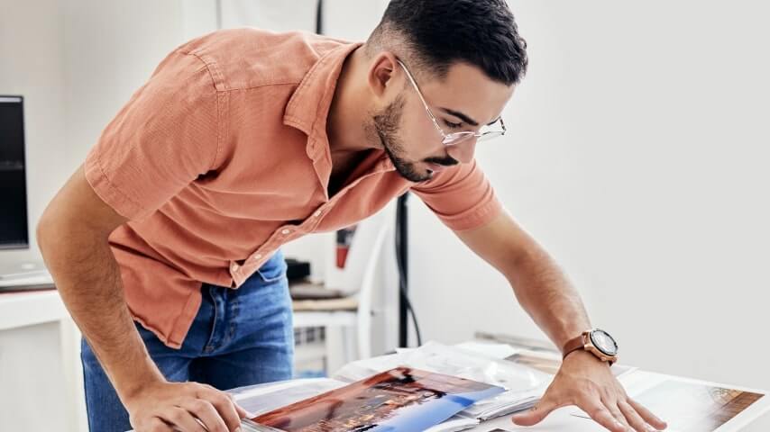 A man selecting the best art print sizes for his photos.