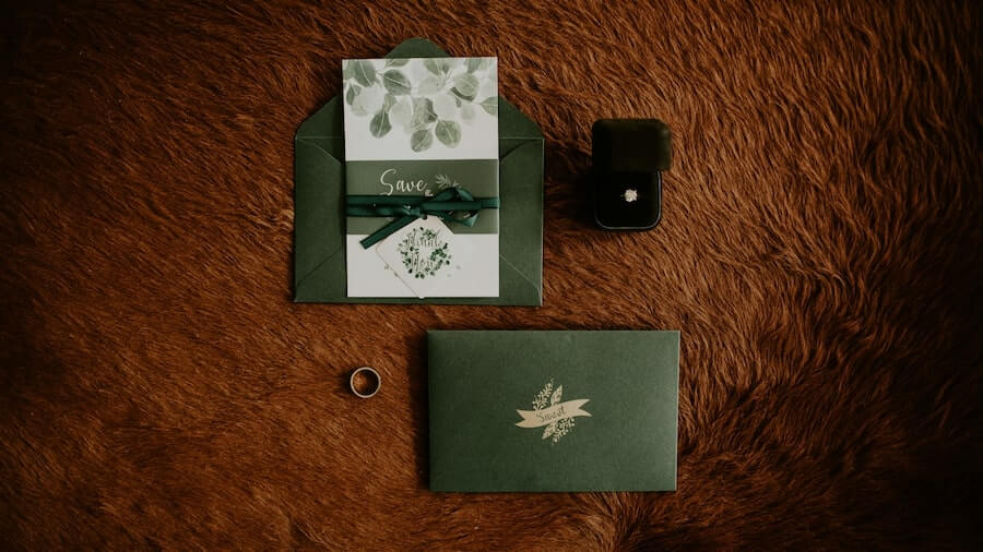 Wedding invitations and event designs Wedding invitation with rings next to it.