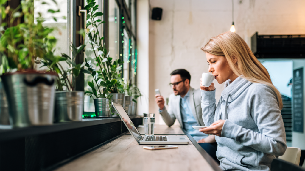 People working with laptops from a coffee shop.