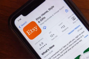 A phone showing Etsy app on the screen.
