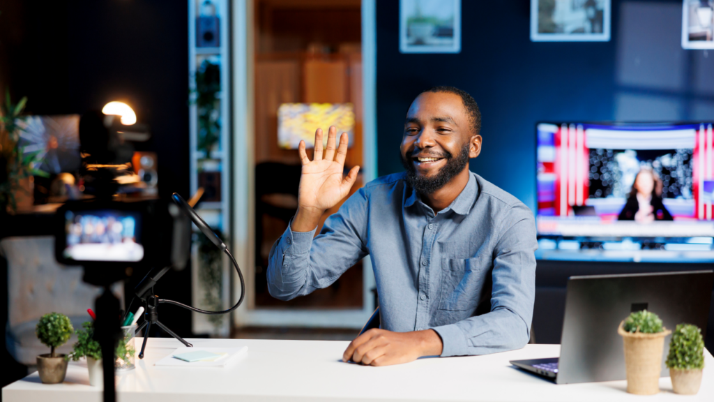 A man sitting in front of a camera and streaming.