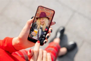 A mobile phone held in hands with the TikTok app open.