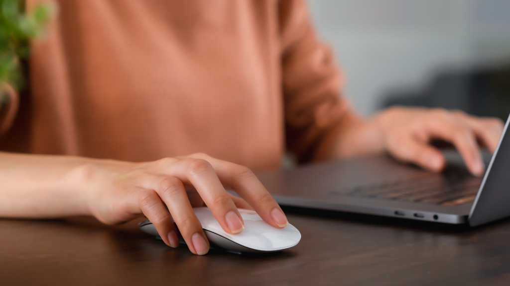 Why should you have an Amazon storefront A person using a laptop with a mouse while sitting at a desk.