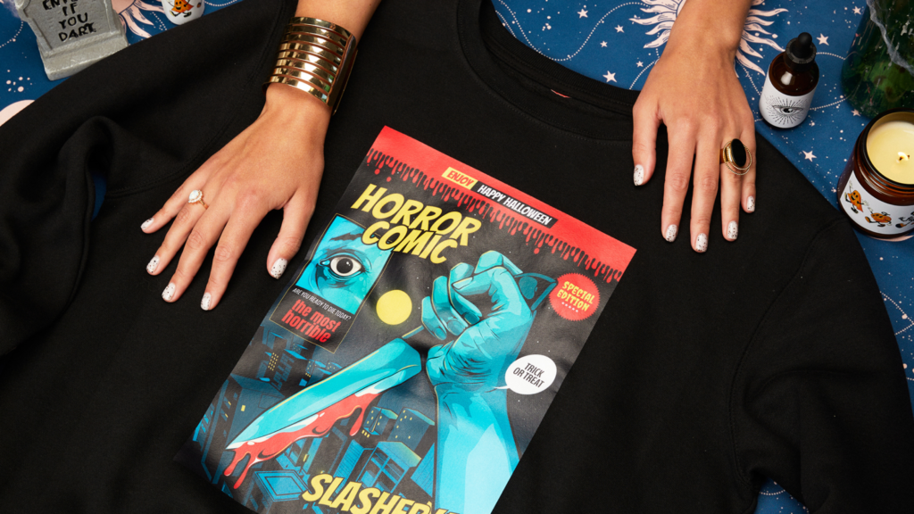 A woman dons a custom sweatshirt adorned with a horror comic.