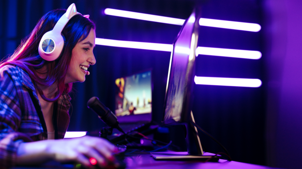 A woman engaged in gaming, wearing headphone and streaming her gameplay.