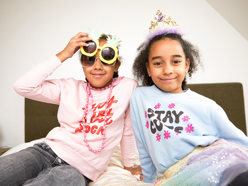 Two kids wearing custom sweatshirts.