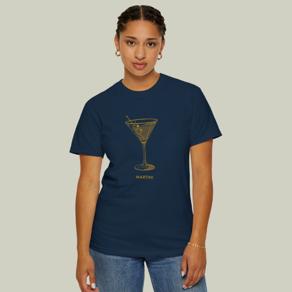 Blue and gold A woman wearing a blue and gold “Martini” t-shirt on a light olive green background.