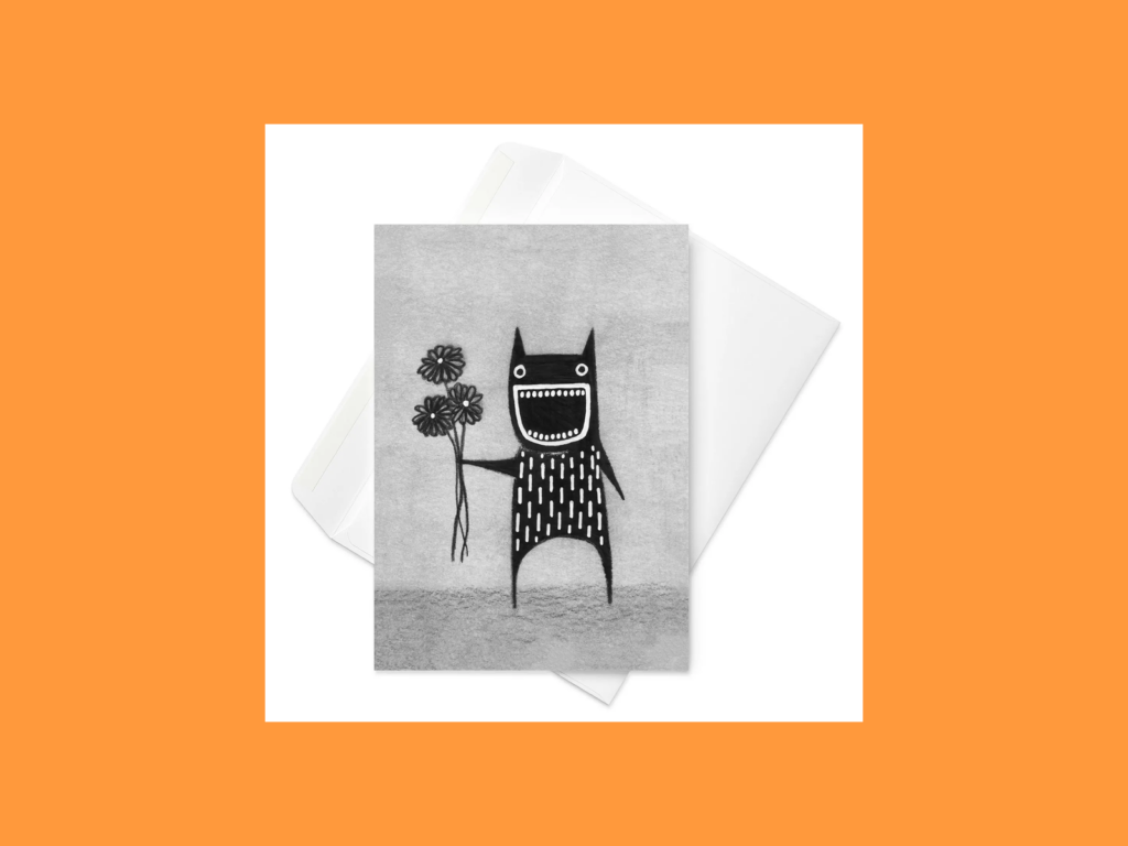 Creepy but cute birthday cards A greeting card with a black monster holding flowers painted on it.
