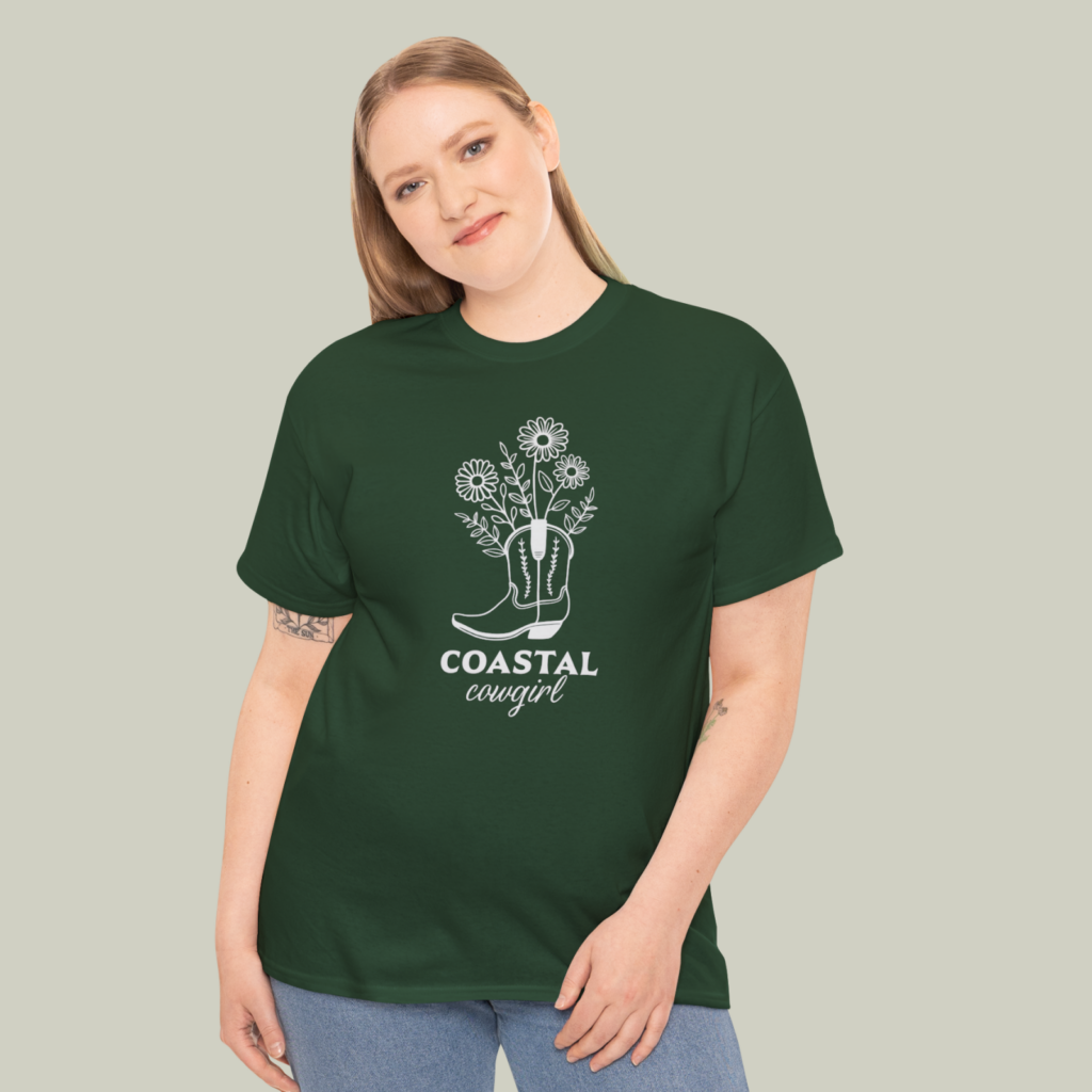 Green and gray A woman wearing a custom green and gray “Coastal cowgirl” t-shirt on a light olive green background.