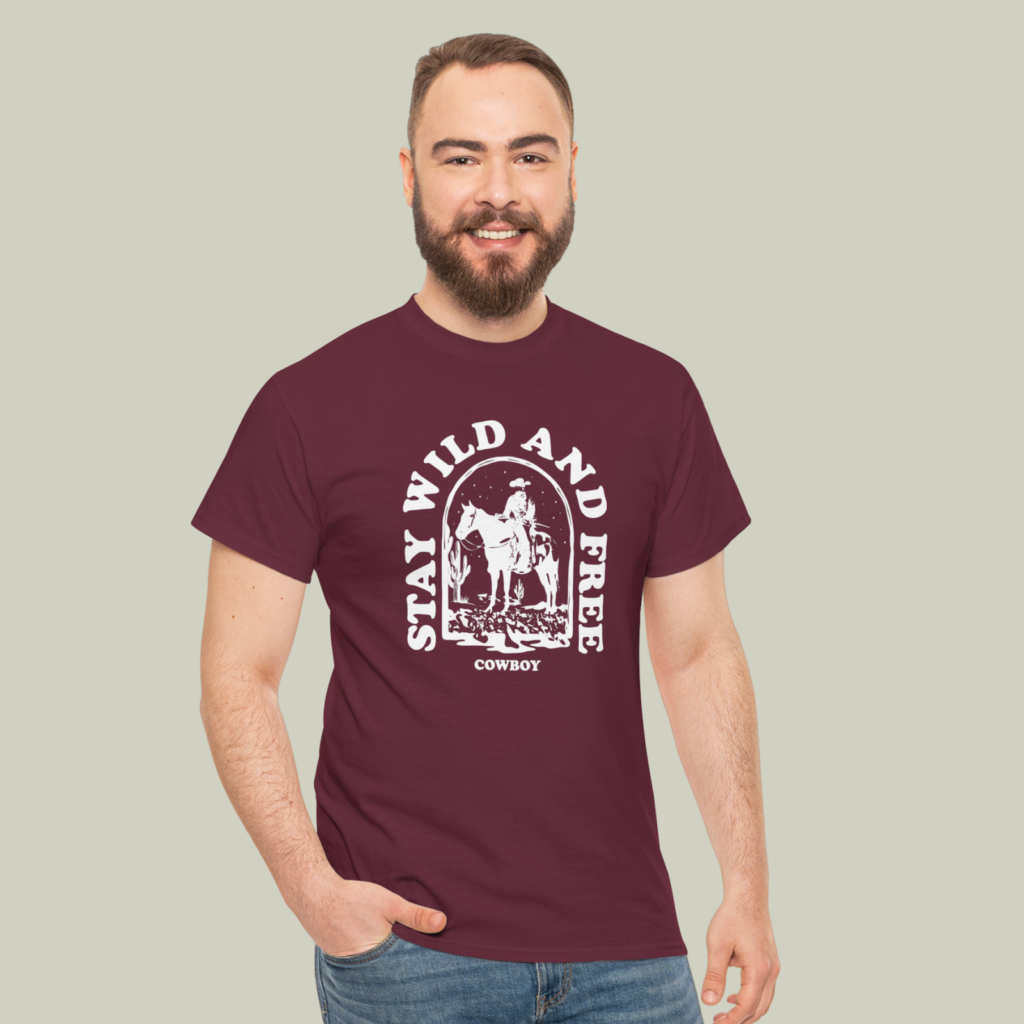 Maroon and white A man wearing a maroon and white “Stay wild and free” t-shirt on a light olive green background.
