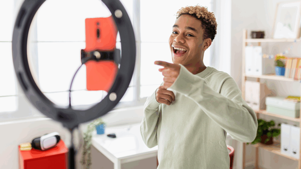 Become a social media influencer A social media influencer recording himself with a mobile phone.