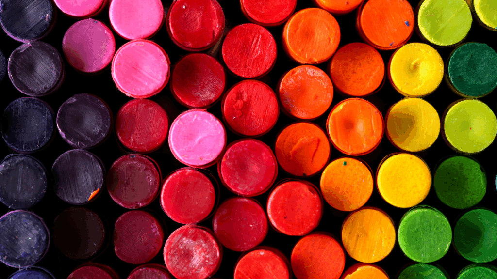 Color range Sublimation vs screen printing A close-up view of a variety of colorful crayons arranged together, showcasing their vibrant hues and textures.