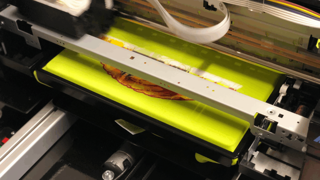 Direct to garment printing DTG Types of shirt printing A direct-to-garment (DTG) printer in the process of printing.