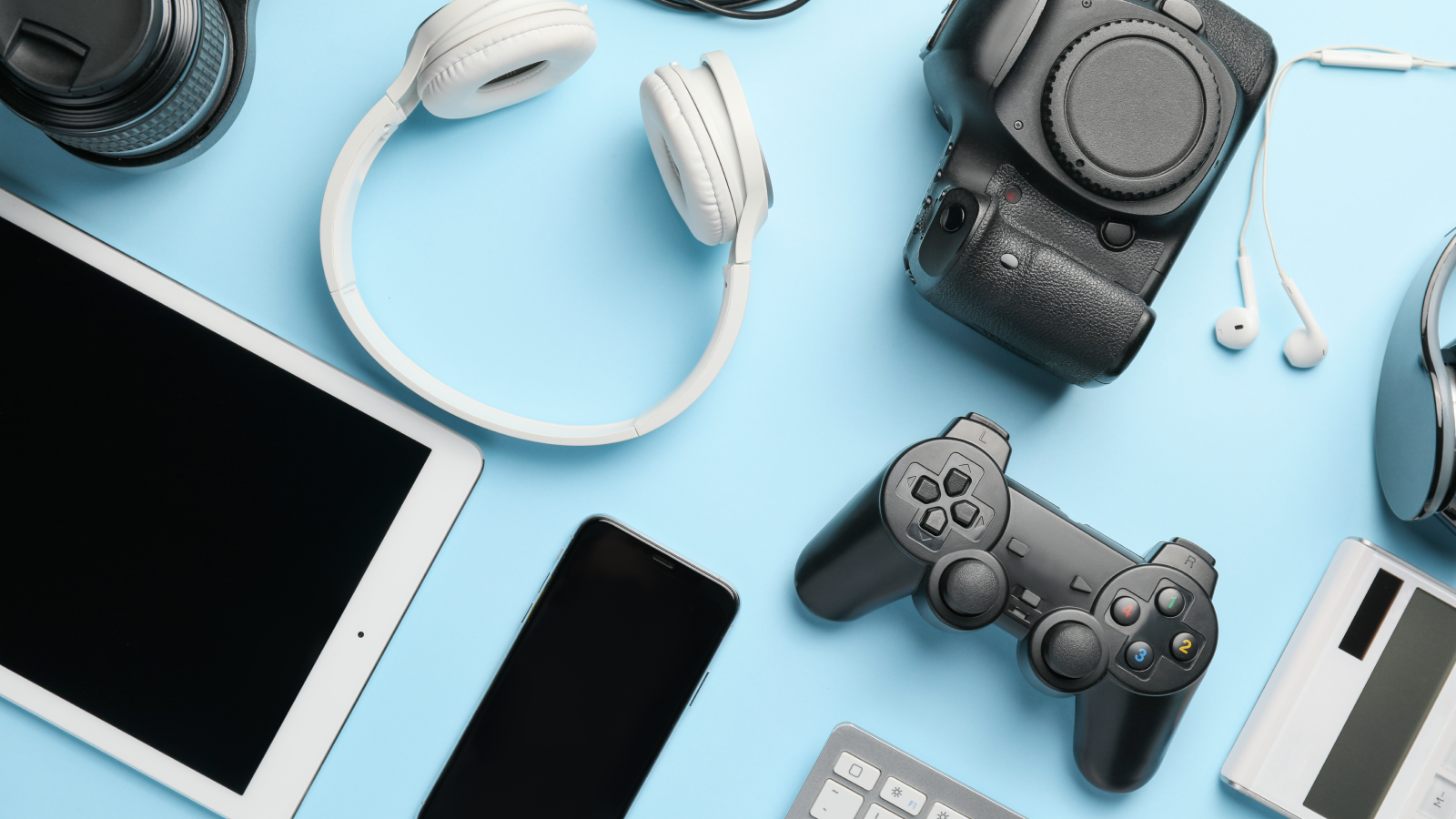 Electronics What to sell on Amazon Various electronics (tablet, laptop, DSLR camera, headphones) on a blue background.