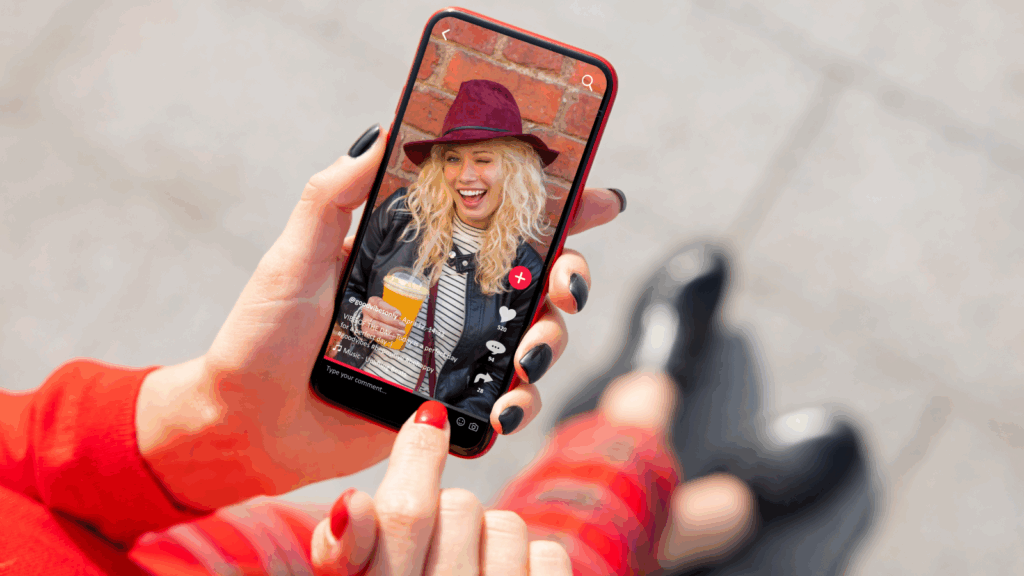 Engage and interact with your audience A woman holding a phone with the TikTok app open.