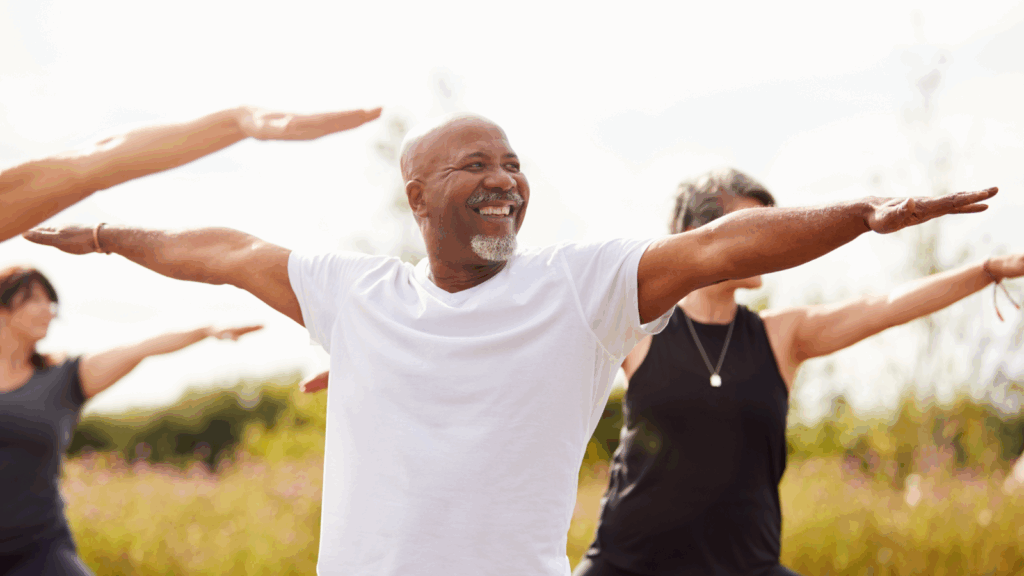 Health and wellness Top 10 most successful businesses to start A smiling man in a white t-shirt performing health exercises.