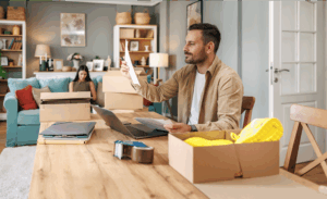 A man looking at papers while running a dropshipping business from home.