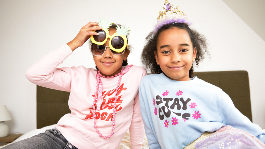 Kids clothing What to sell on Shopify Two kids wearing custom sweatshirts as an example of what to sell on Shopify.