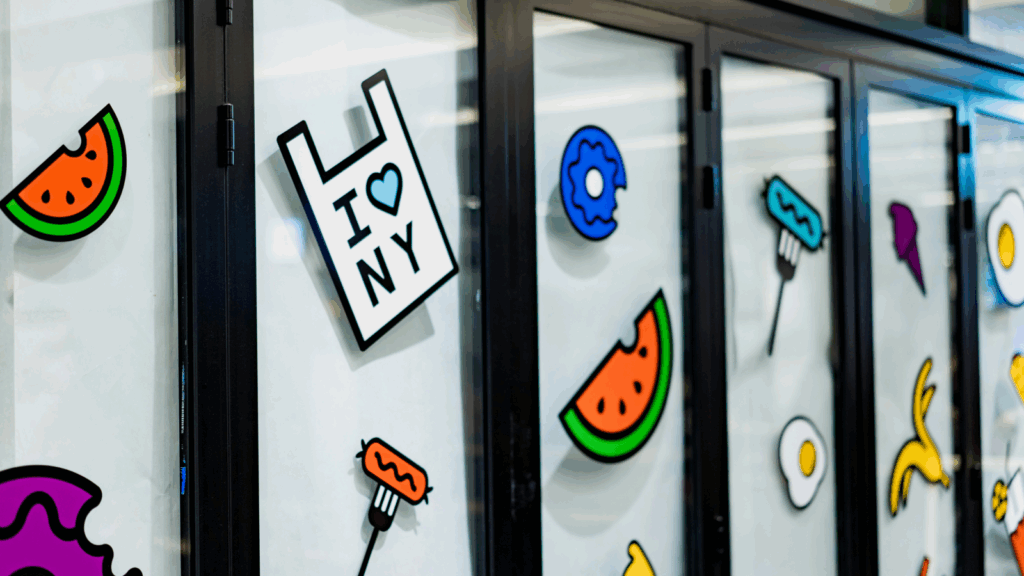 Kiss cut stickers High margin products A wall covered in an assortment of bright stickers, showcasing a lively and artistic display.